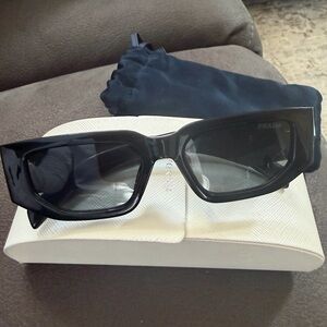 Prada Glossy Black Sunglasses with Gold Logo Plaque